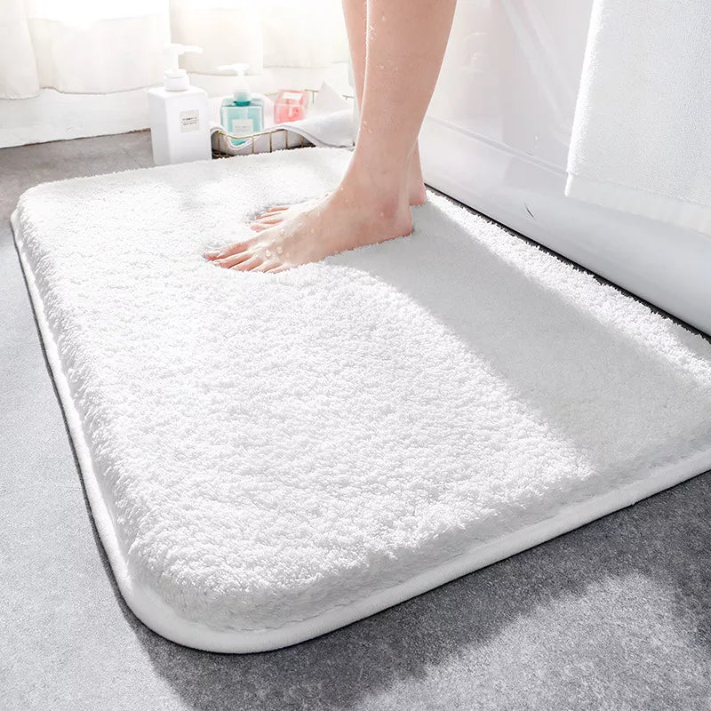 Thick soft-pile rectangular bathroom mat with rounded corners and a non-slip base