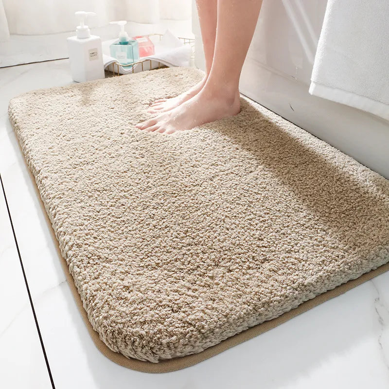 Thick soft-pile rectangular bathroom mat with rounded corners and a non-slip base