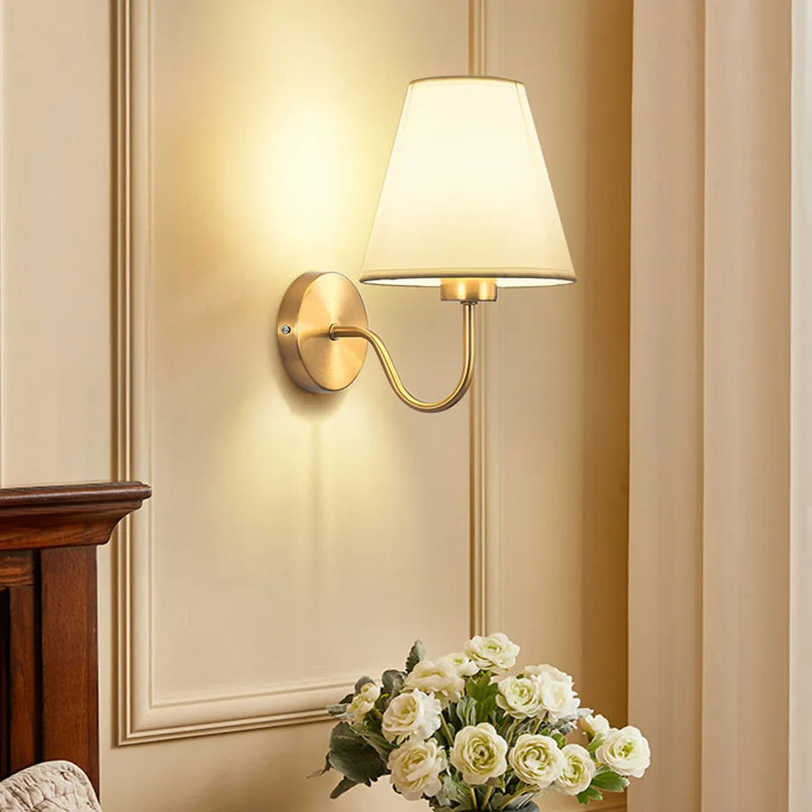 Wall lamp with tapered fabric shade and curved arm