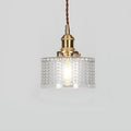 Round glass pendant light with textured shade and brass fitting