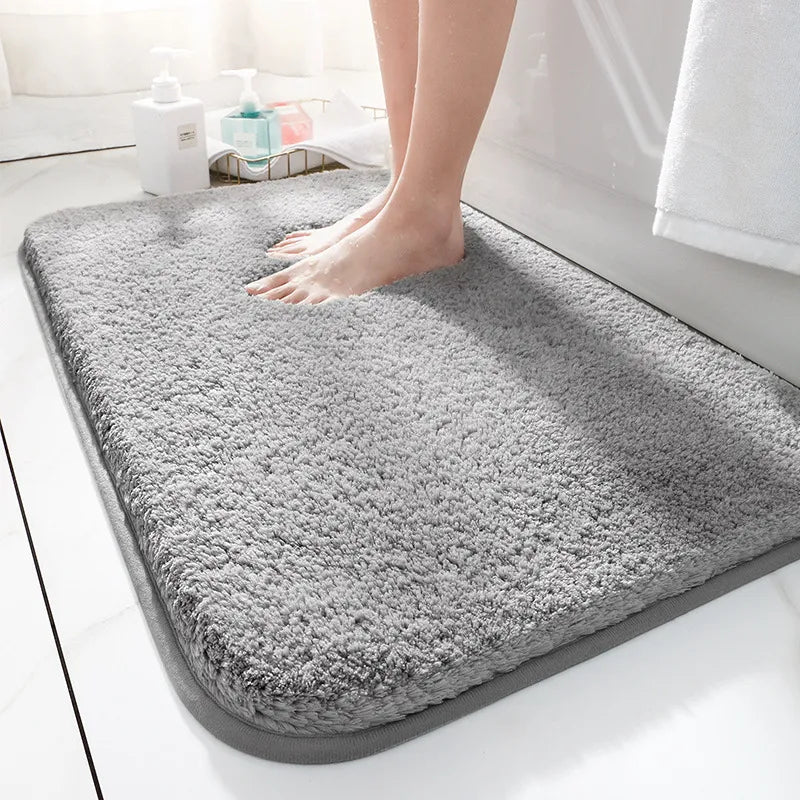 Thick soft-pile rectangular bathroom mat with rounded corners and a non-slip base