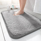 Thick soft-pile rectangular bathroom mat with rounded corners and a non-slip base
