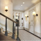 Wall lamp with tapered fabric shade and curved arm