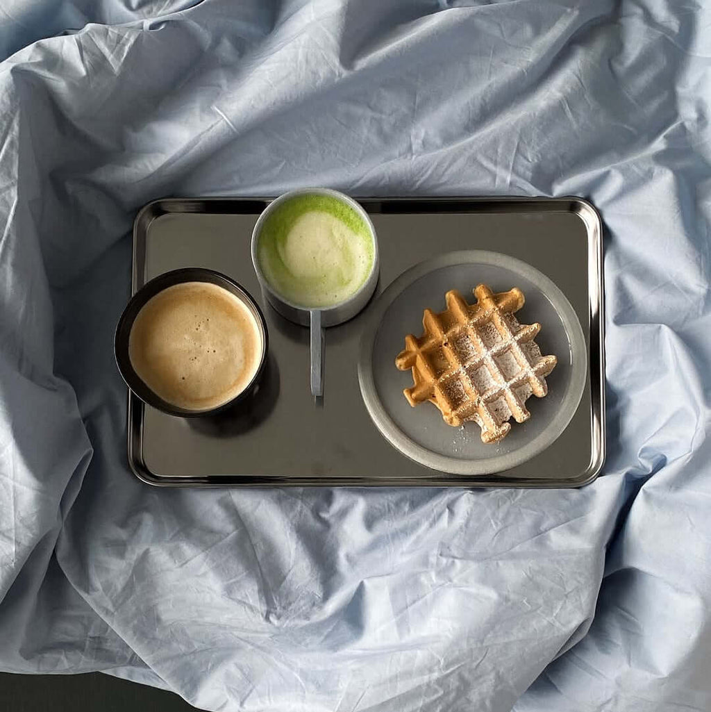 Rectangular stainless steel serving tray with raised edge