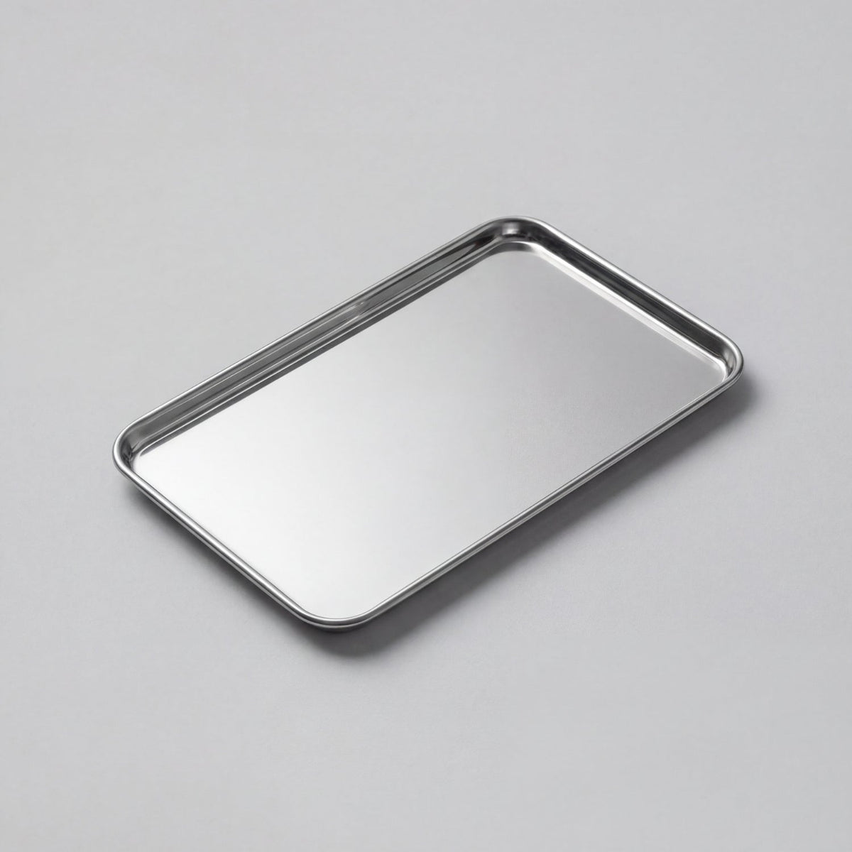 Rectangular stainless steel serving tray with raised edge