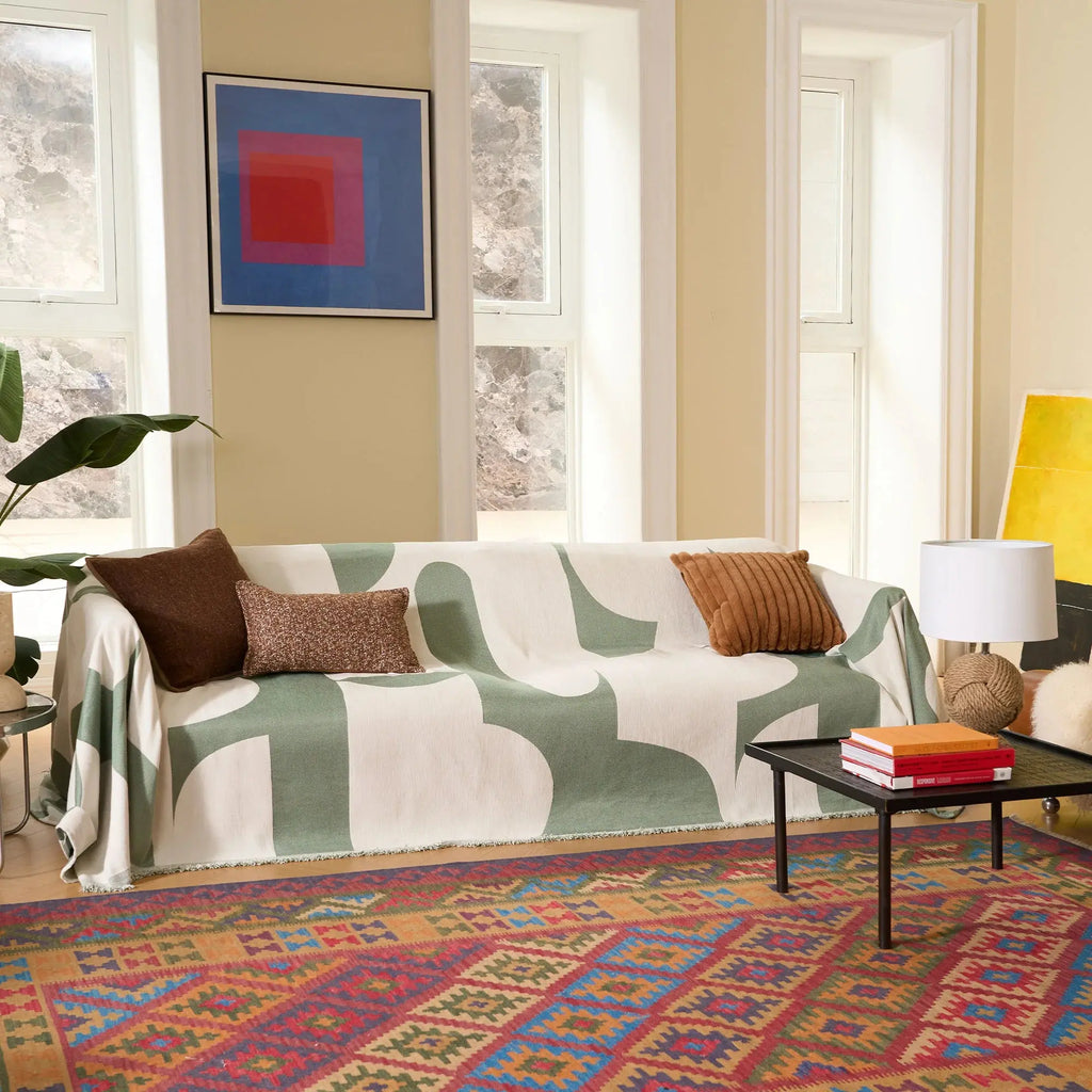 Geometric chenille sofa cover with fringed edge