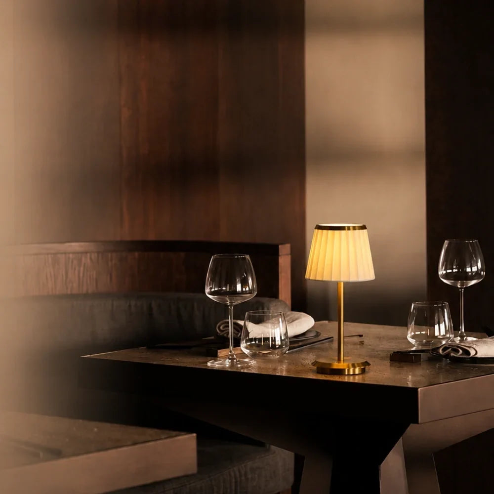 Table lamp with pleated shade, slim stem and round base