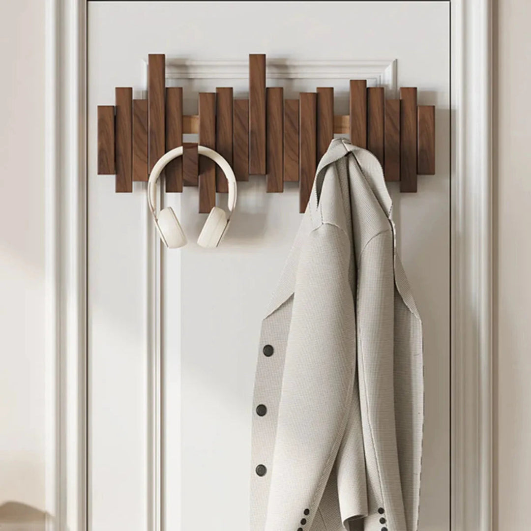 Wall-mounted coat rack with slatted panel and fold-down hooks
