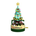 Green Christmas tree music box with hand crank, train scene and festive decorations