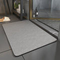 Plain rectangular bathroom floor mat with rounded corners and dark edging