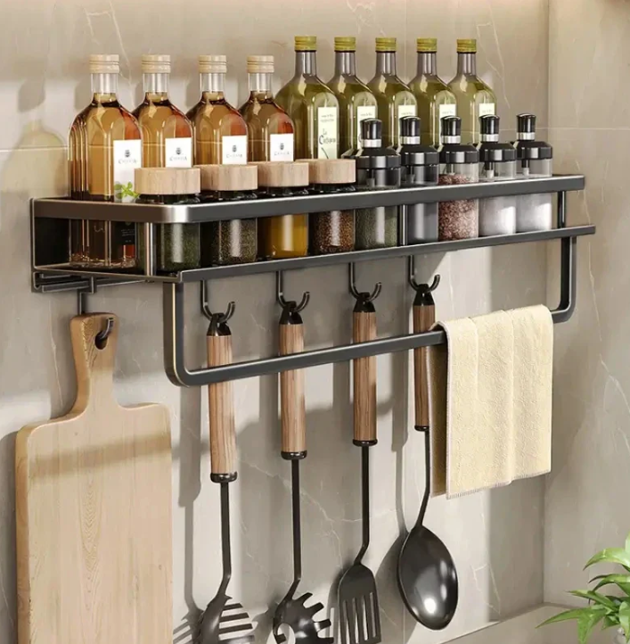 Black wall-mounted kitchen storage shelf with towel holder and hooks