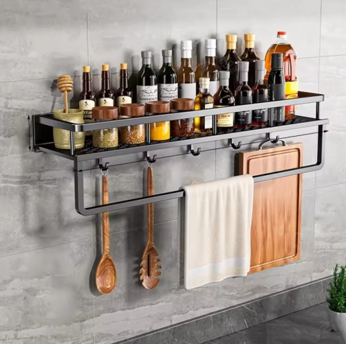 Black wall-mounted kitchen storage shelf with towel holder and hooks