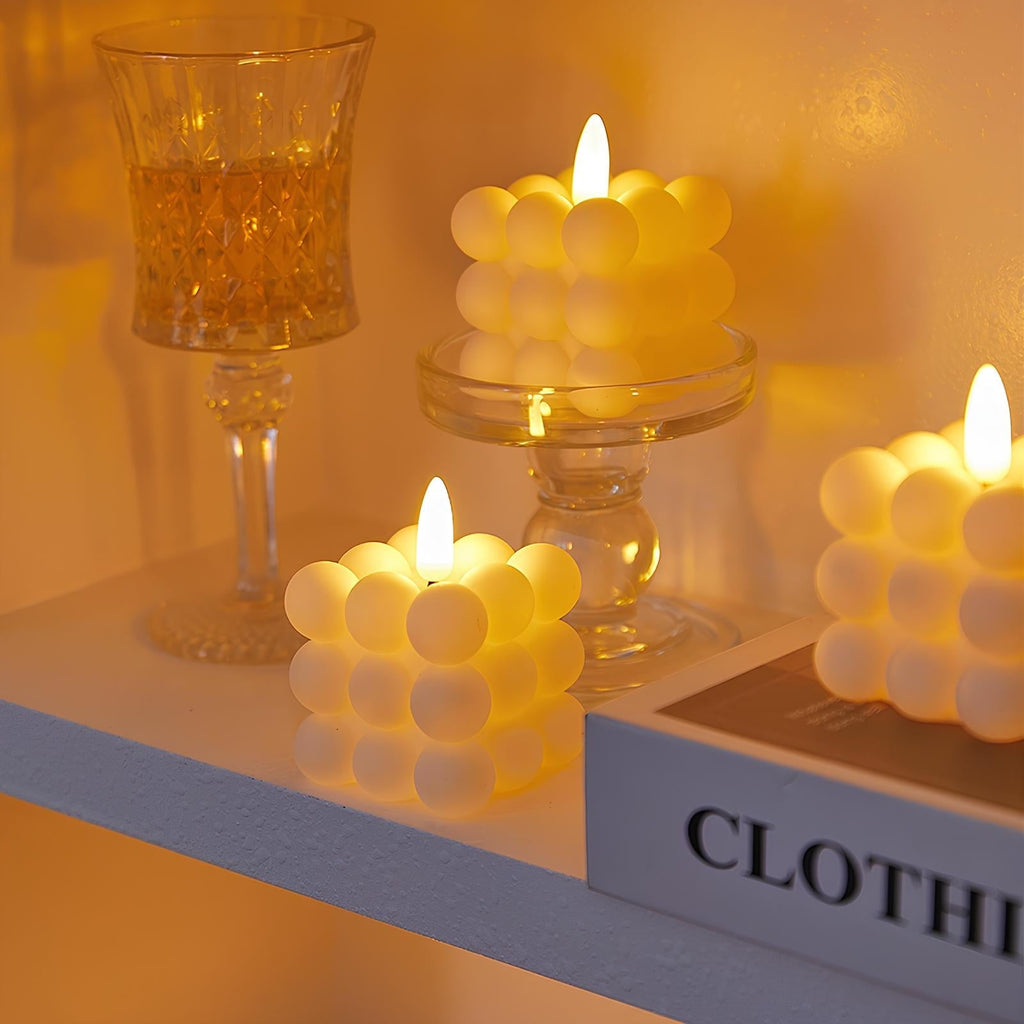 LED flameless candles with flickering flame-shaped lights in pillar and pumpkin-inspired designs