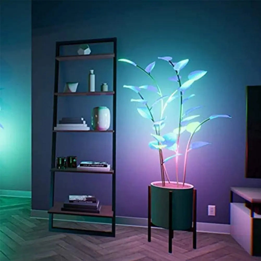 App-controlled LED plant light with glowing leaves in a white pot