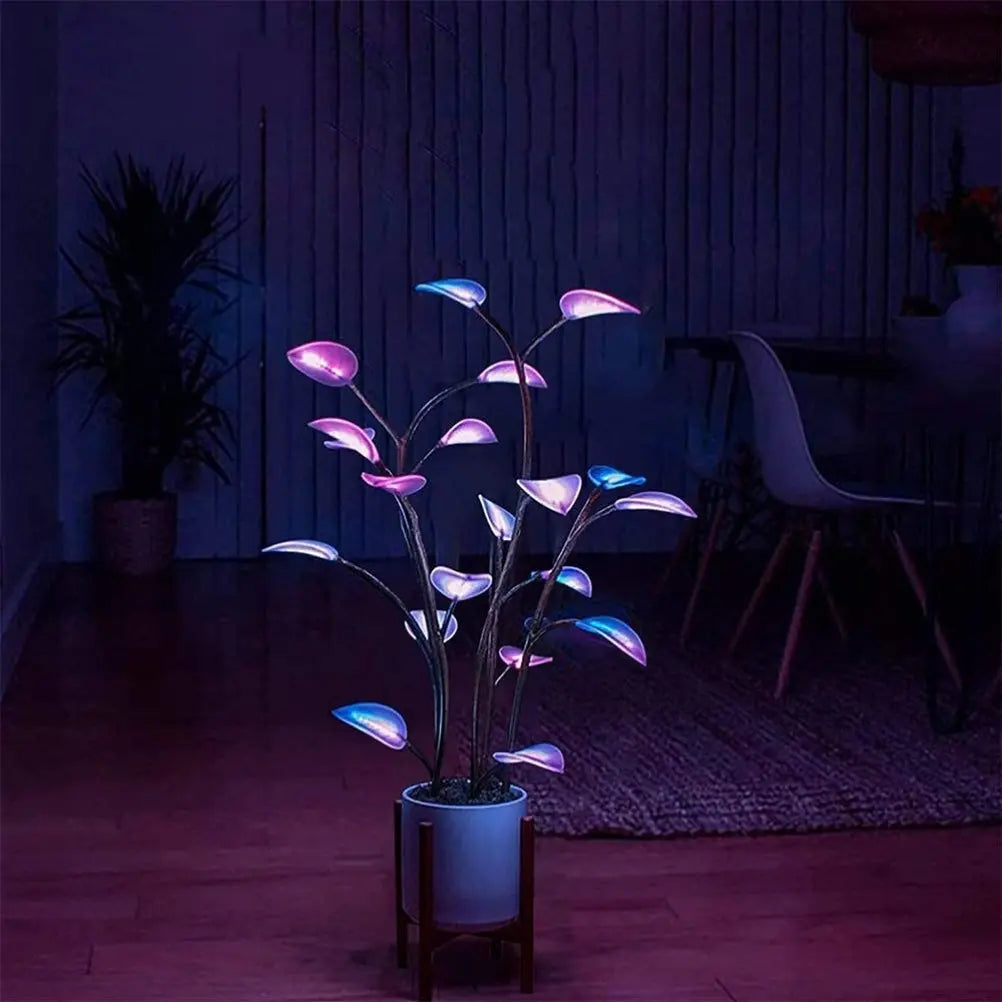 App-controlled LED plant light with glowing leaves in a white pot