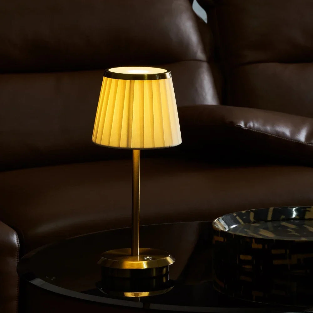 Table lamp with pleated shade, slim stem and round base