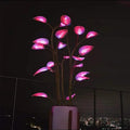 App-controlled LED plant light with glowing leaves in a white pot