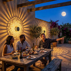 Black cylindrical solar mandala projector light casting a patterned glow outdoors