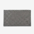 Rectangular textured chenille bath mat with bound edge