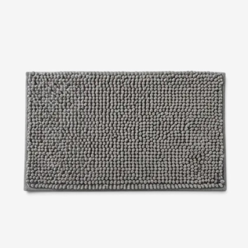 Rectangular textured chenille bath mat with bound edge