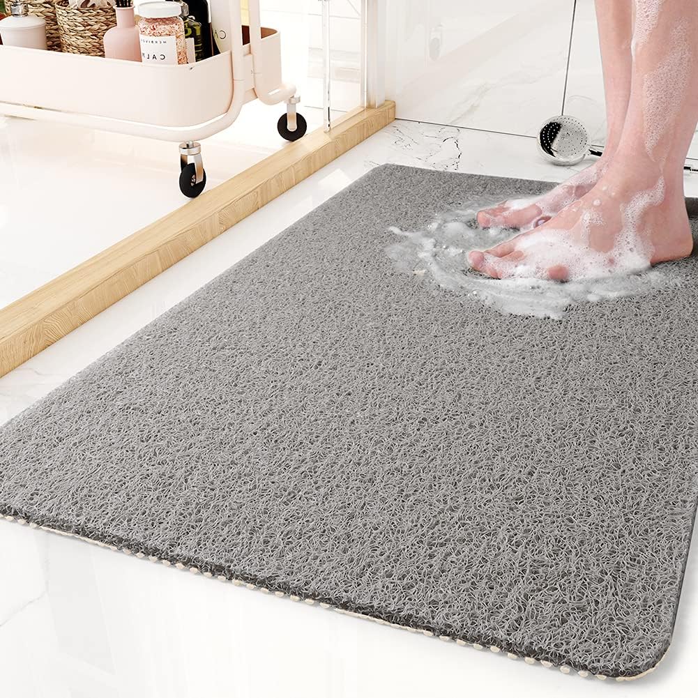 Textured non-slip bathroom mat beside a shower