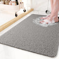 Textured non-slip bathroom mat beside a shower