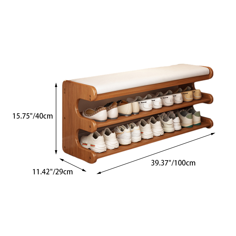 Brown bamboo shoe bench with white padded seat and two open storage shelves