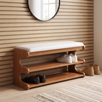 Brown bamboo shoe bench with white padded seat and two open storage shelves