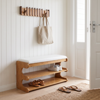 Brown bamboo shoe bench with white padded seat and two open storage shelves
