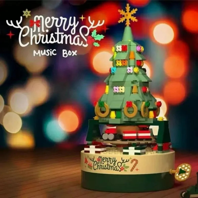 Green Christmas tree music box with hand crank, train scene and festive decorations