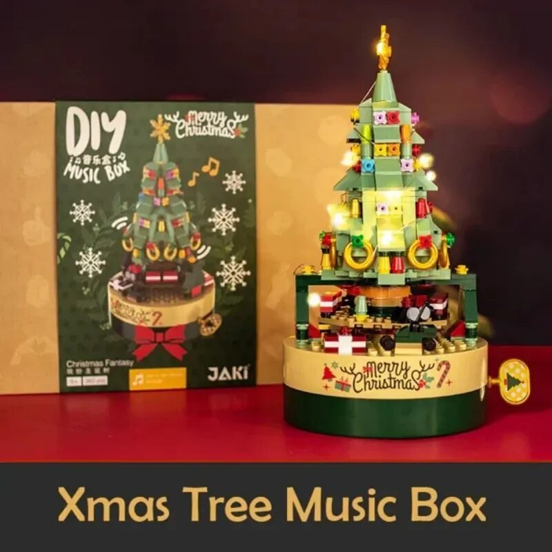 Green Christmas tree music box with hand crank, train scene and festive decorations