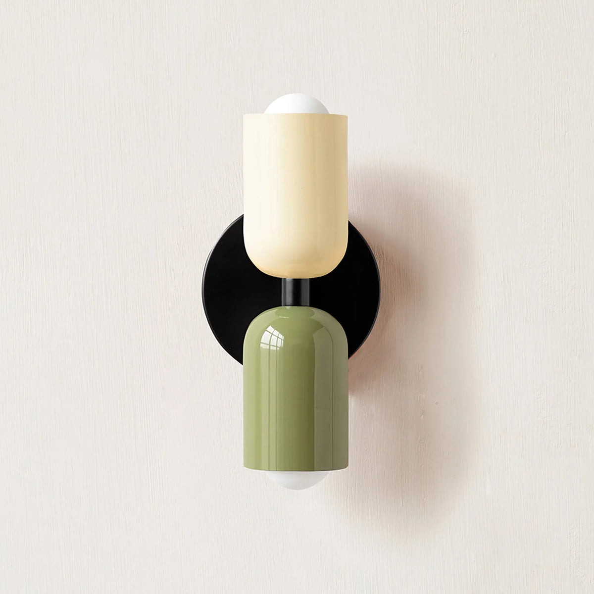 Modern wall light with two cylindrical shades and a round backplate