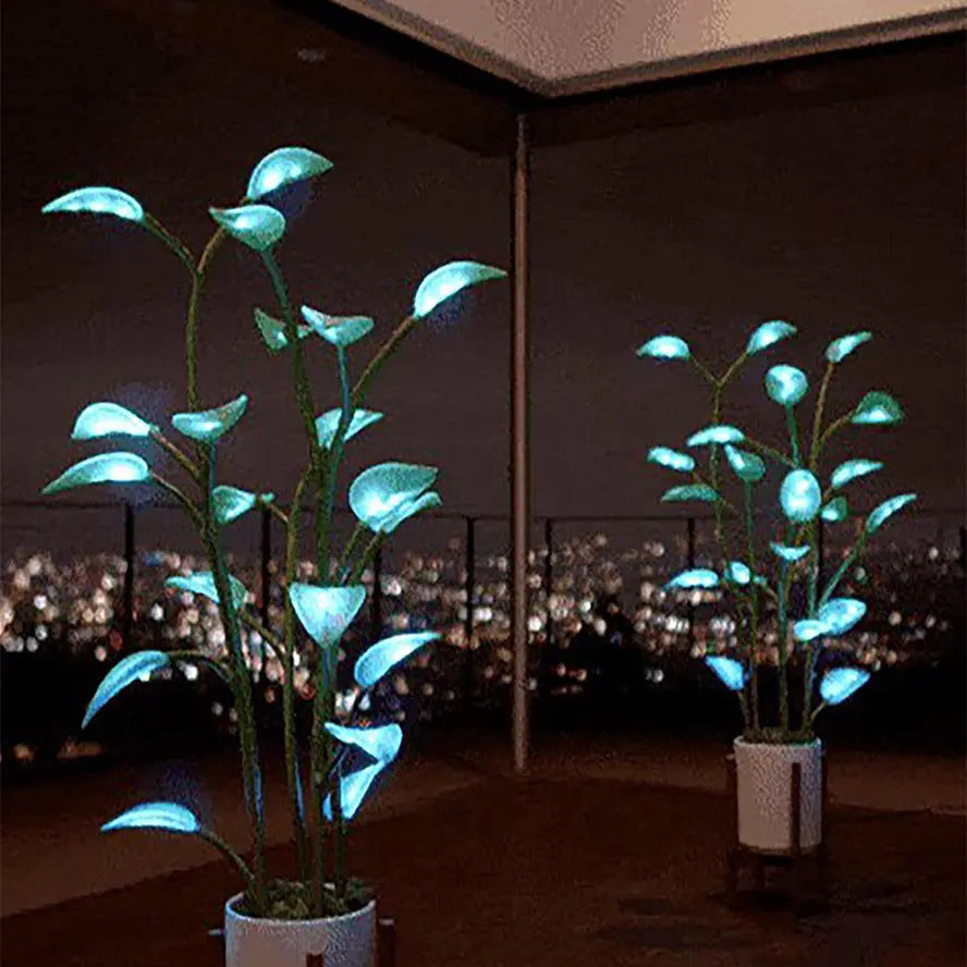 App-controlled LED plant light with glowing leaves in a white pot