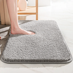 Thick soft-pile rectangular bathroom mat with rounded corners and a non-slip base