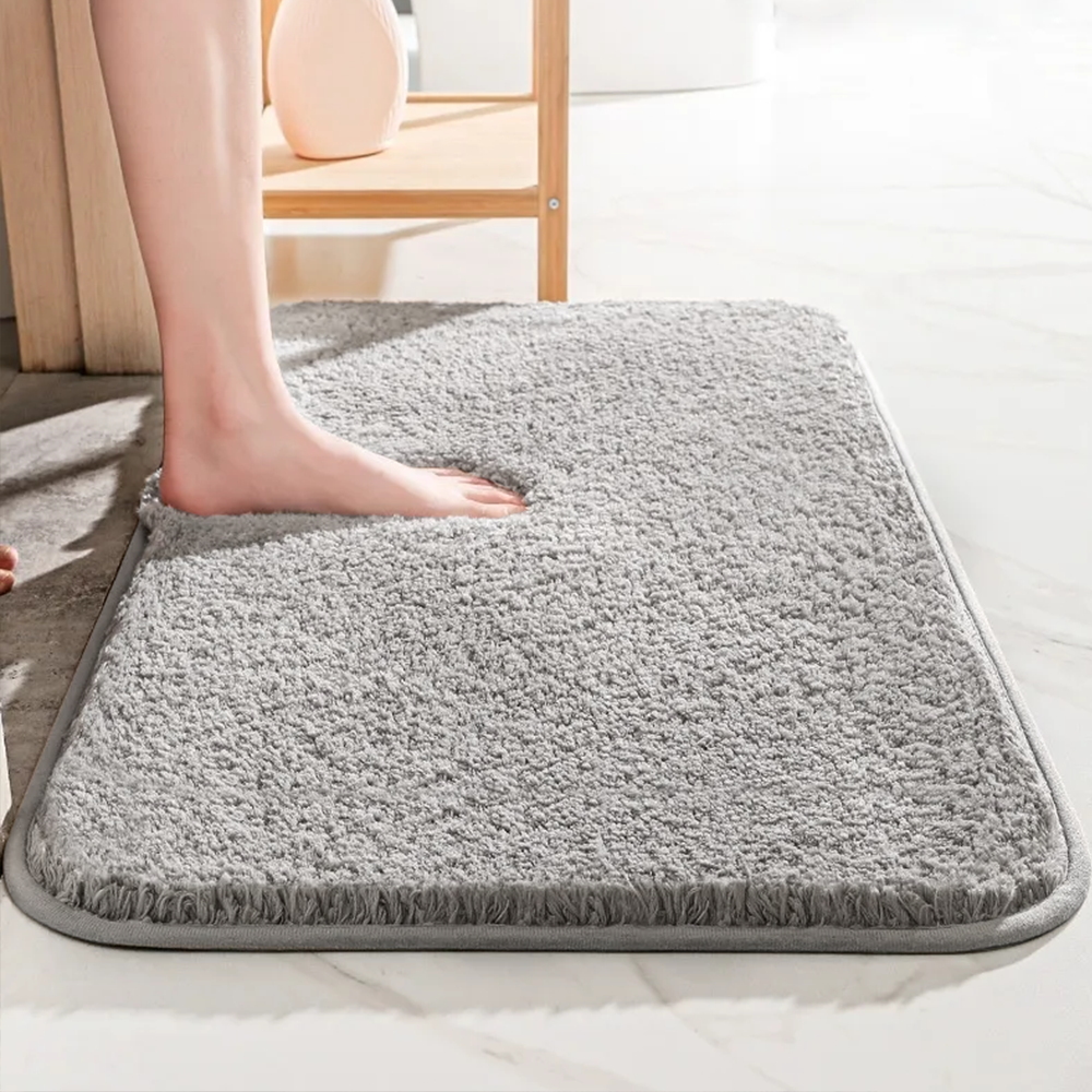 Thick soft-pile rectangular bathroom mat with rounded corners and a non-slip base
