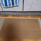 Rectangular textured pile door mat with bound edges