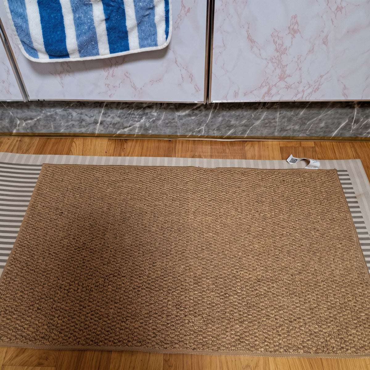 Rectangular textured pile door mat with bound edges