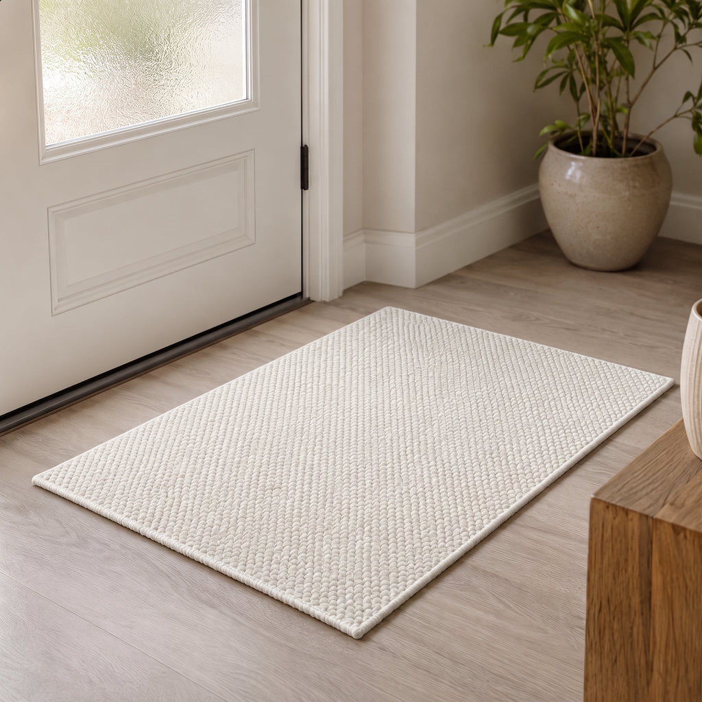Rectangular textured pile door mat with bound edges
